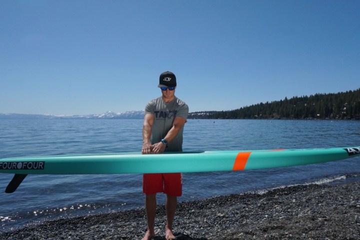 a person riding a surf board on a body of water